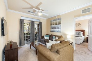 Relax in this inviting living space with a sofa, coffee table, and television.