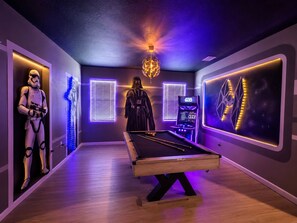 A pool table in a room with Star Wars-themed decor, including a Stormtrooper and Darth Vader statues. - Luxury 12 B.R 11.5BA 15 B.D in upscale community Pool/Game Close to Disney (Kissimmee)