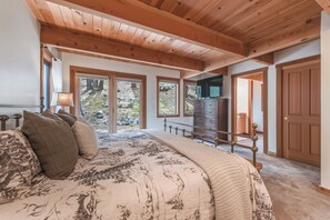 A bedroom with a large bed, a dresser, and a television. - Cozy Northstar Home ~Northstar Mountain~ (Truckee)