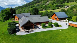 A lodge with a covered patio, a dining area, and a large open space.