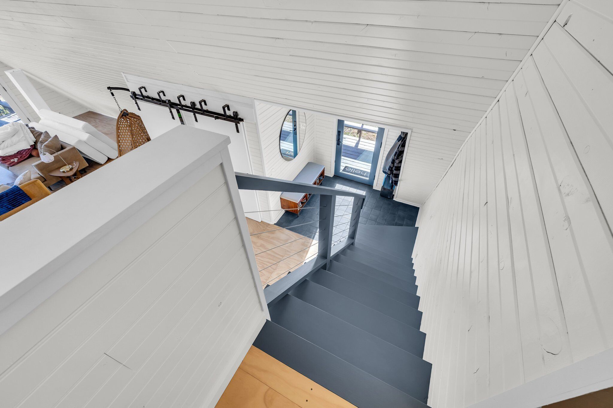 A modern interior with a staircase leading to a lower level.