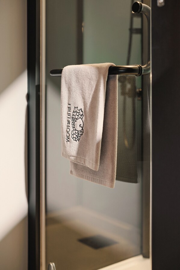 A towel hanging on a metallic towel rack with a visible logo.