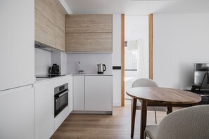 Enjoy cooking and dining in this well-equipped kitchen with oven, coffee maker, and kettle.
