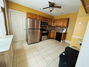 Enjoy cooking in this well-equipped kitchen with a refrigerator, dishwasher, and ample counter space.