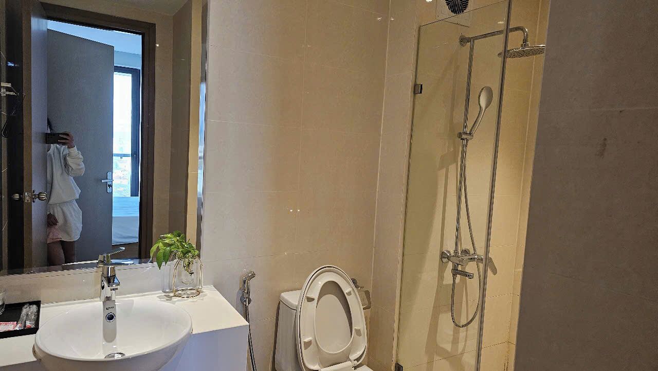 A bathroom with a sink, toilet, and shower.