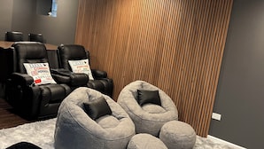 A modern living room with a sectional sofa, a recliner, and a large rug.