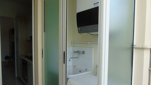 A compact kitchen with a microwave, a sink, and a dishwasher.