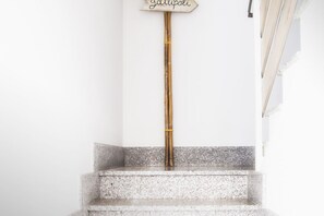 A staircase with a bamboo pole and a sign that reads "Gullipoli."