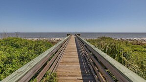 A wooden boardwalk leading to a beach with clear skies. - Large Family Home, Pool, Pet Friendly and Steps from the Beach (Jekyll Island)