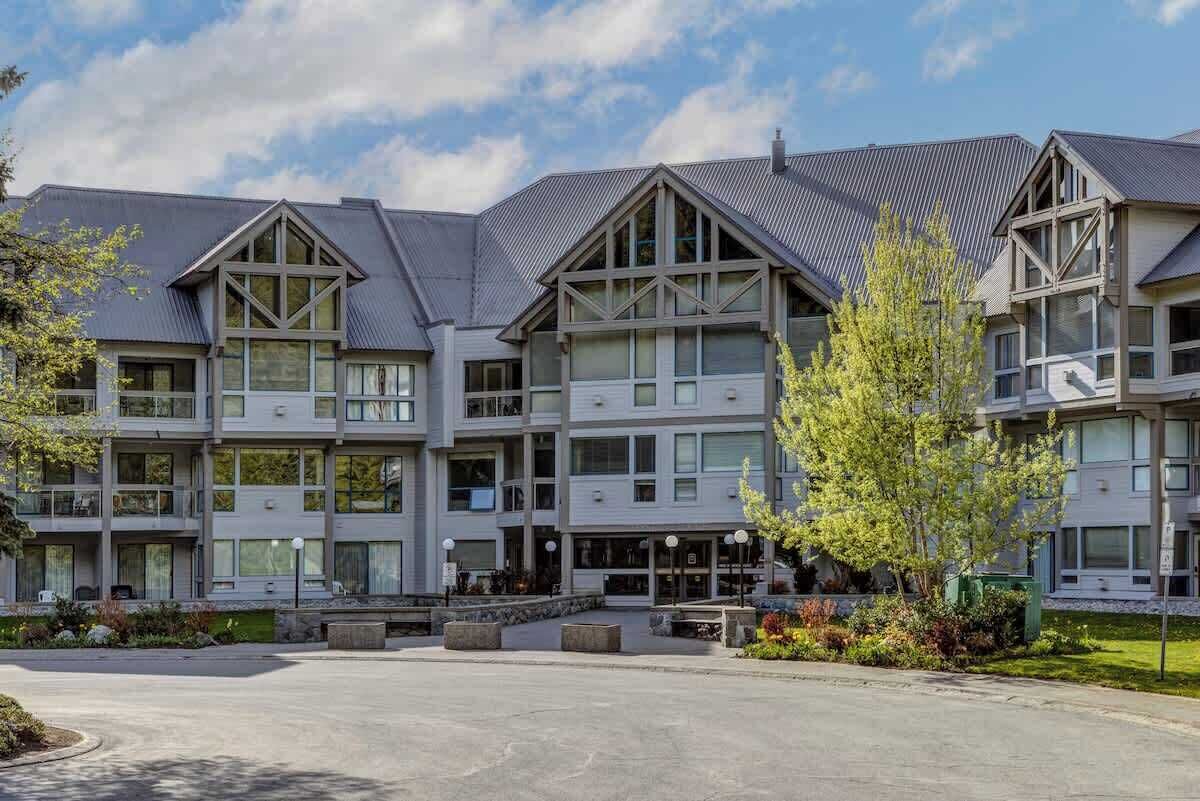 A multi-story hotel with a central courtyard, large windows, and a modern architectural design.