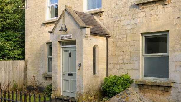 A stone building with a sign reading "The Rectory."
