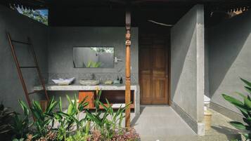 Bathroom features a sink and mirror, with a small window above.