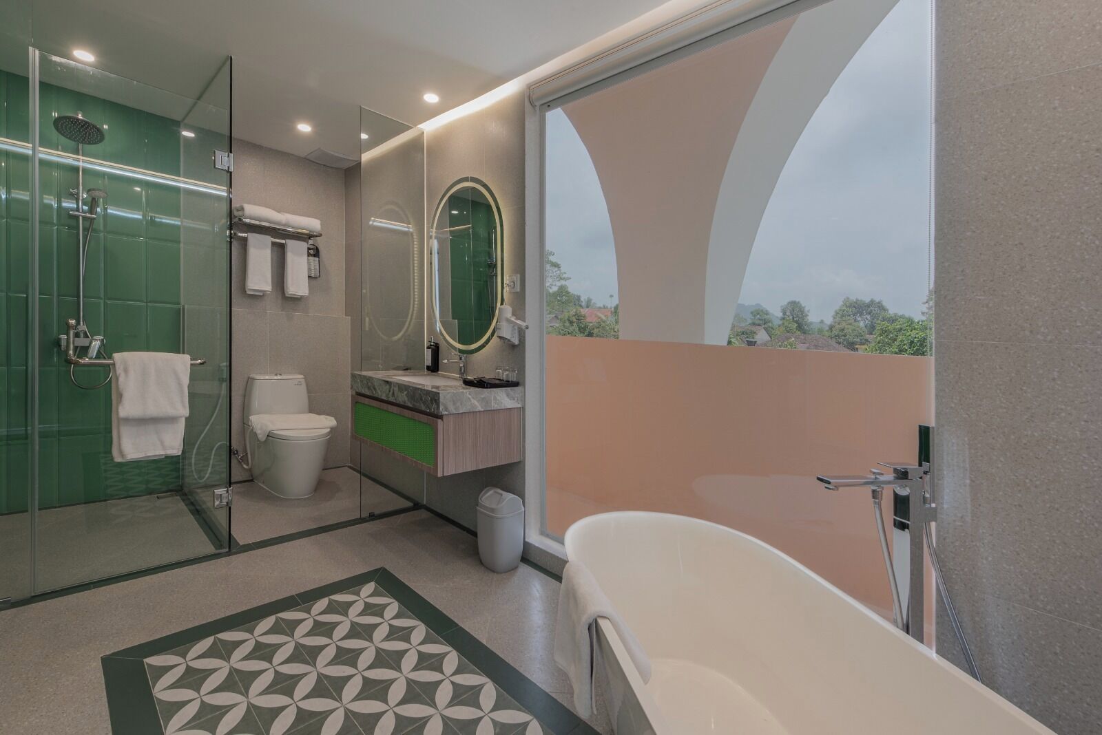 A modern bathroom with a glass-enclosed shower, a freestanding bathtub, and a large mirror.