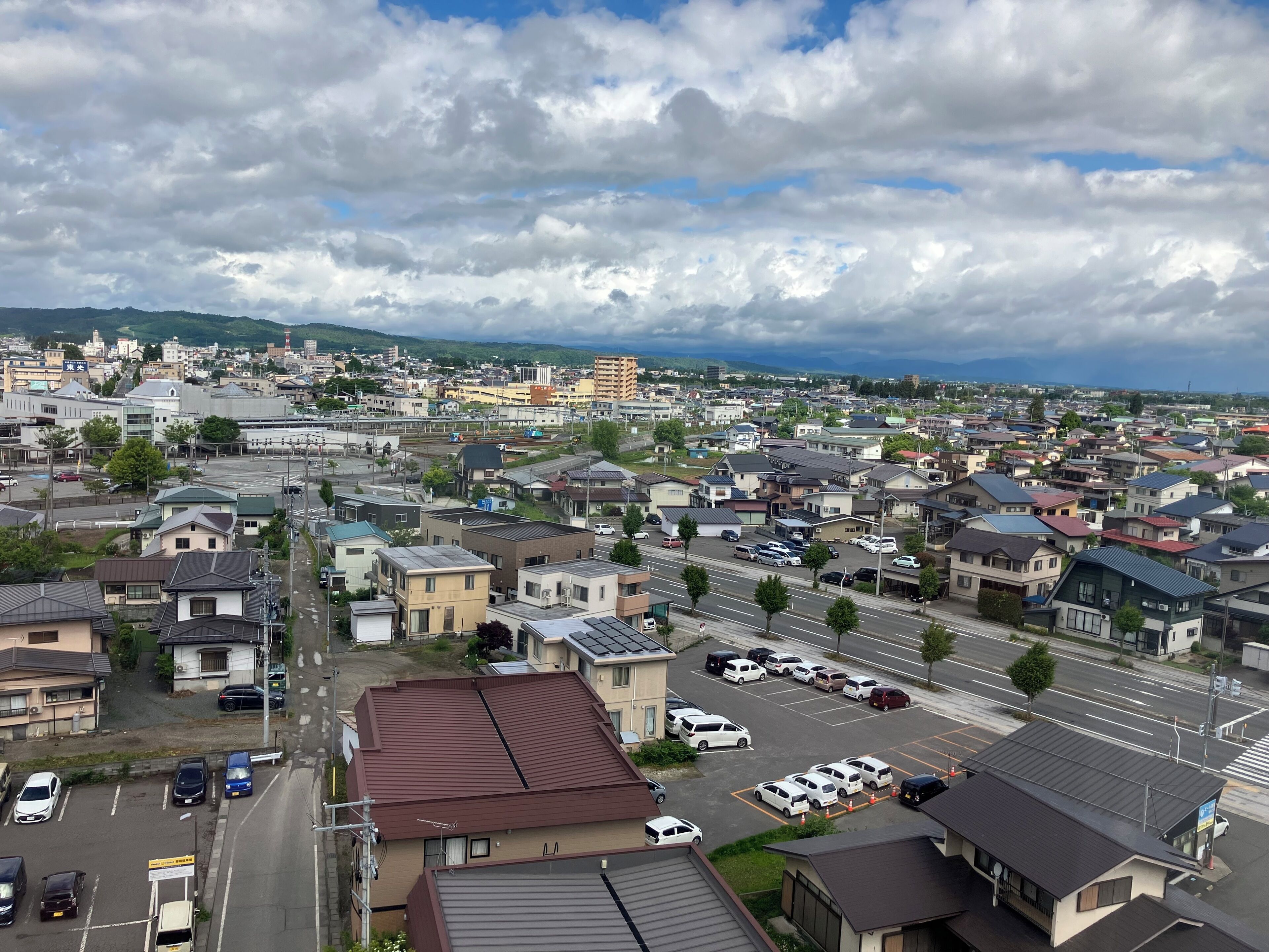 A residential area with houses, streets, and parked cars.