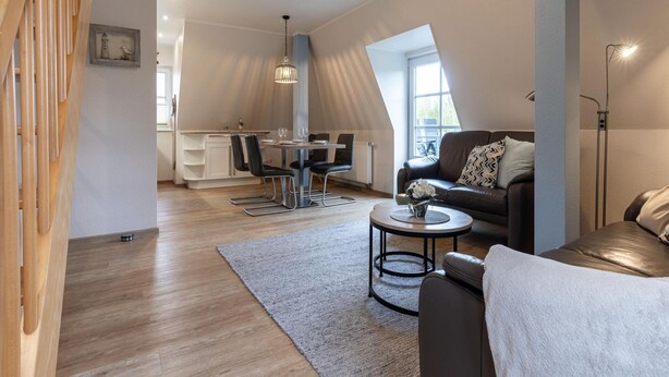 Una sala de estar moderna con un sofá, una mesa de centro y un comedor.