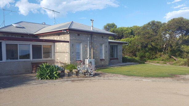 A two-story house with a garage, a driveway, and a lawn. - Hillocks Homestead Overlooking the Bush (Marion Bay)