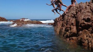 A rocky coastline with waves crashing against the rocks. - Poolside Ocean View Pod (Marion Bay)