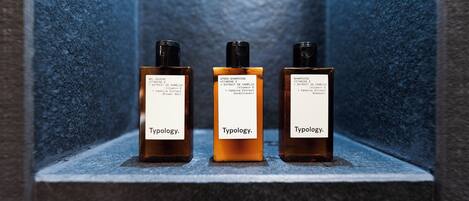 Three bottles of Typology shampoo on a shelf.