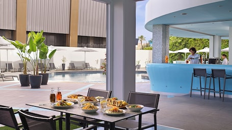 Una piscina al aire libre de temporada, sombrillas. TSANotel