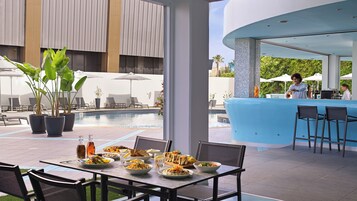 Seasonal outdoor pool, open 9:00 AM to 7:00 PM, pool umbrellas