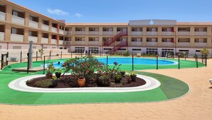 A hotel courtyard with a swimming pool, multiple balconies, and a central staircase. - Charming Studio with Terrace and Sea Views, in Costa del Silencio (Costa del Silencio)