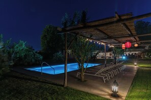 An outdoor pool area with a pergola, string lights, and a small water feature. - Casa Bianca: Town Centre & Private Swimming Pool (Massa Lubrense, Napoli)