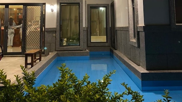 A multi-story building with a swimming pool, balconies, and a covered patio area. - Chumentata (Jinsha)