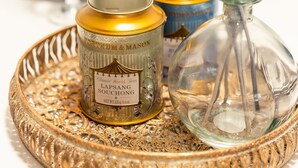 A tray with two jars and a glass bottle, possibly containing tea or spices, on a decorative tray. - Durham Deluxe Apartment With Stunning Views (Durham)