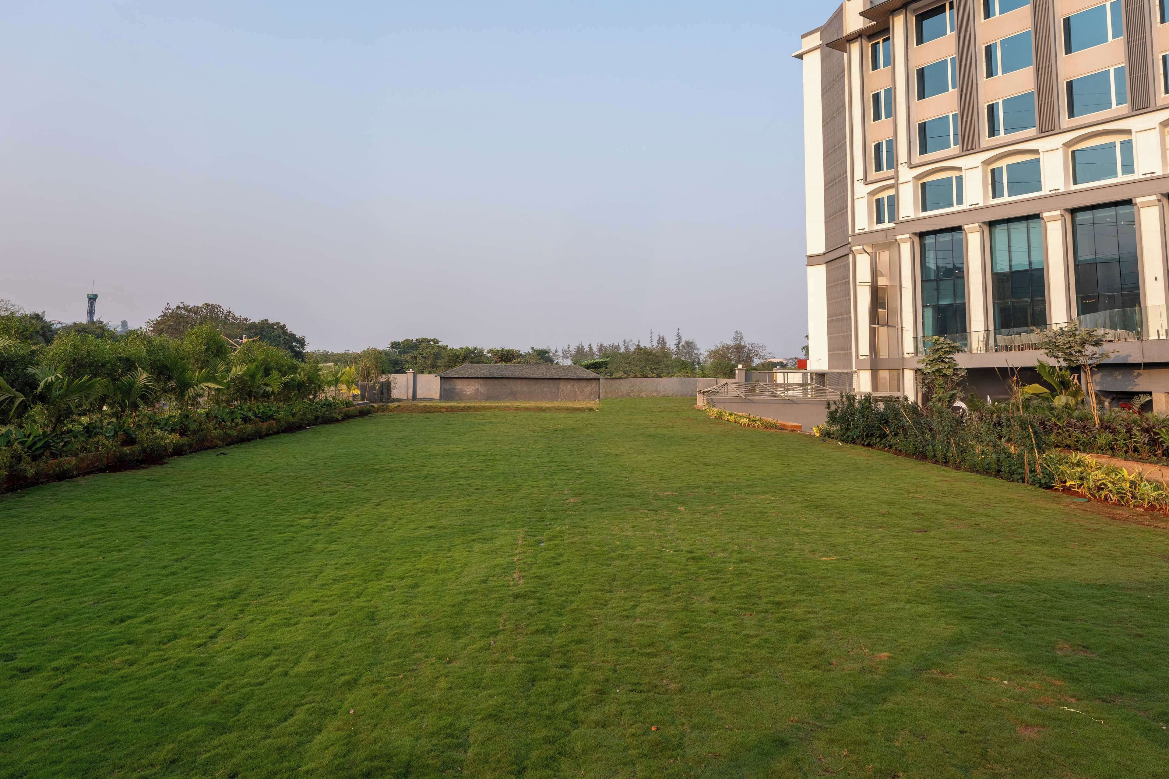 A modern building with large windows and a well-maintained lawn.
