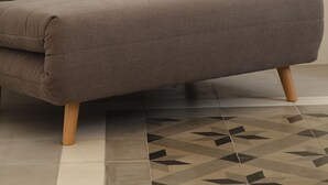 A modern sofa with wooden legs in a minimalist room. - FalcoMarino (Polignano a Mare)