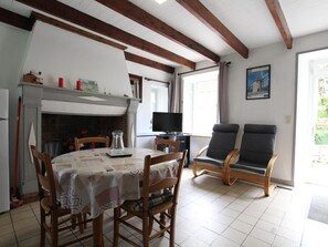 Enjoy a warm and inviting space with a dining table, fireplace, and comfortable seating area.
