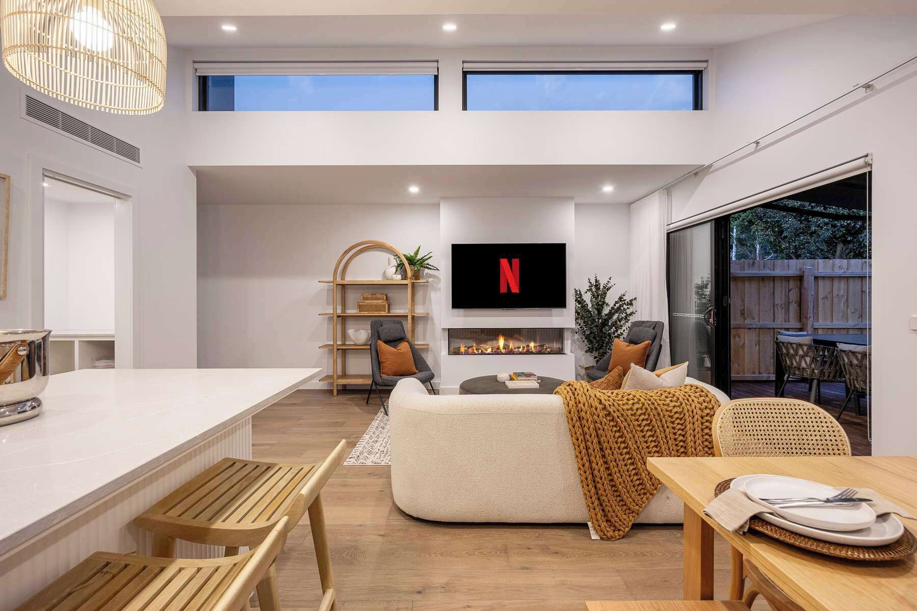 A modern living space with a kitchen, dining area, and seating area.