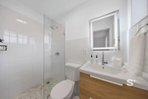 Shower, hair dryer, towels, shampoo
