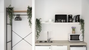 Eine moderne Küche mit integriertem Geschirrspüler, Mikrowelle und Kaffeemaschine auf der Arbeitsplatte.