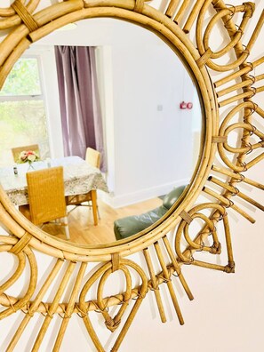 Enjoy a meal in the dining area with a table set for two, a chair, and a vase with flowers.