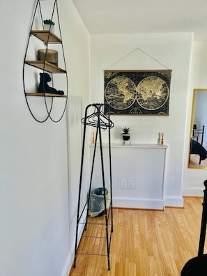 Cozy retreat with a world map above a console table, a ladder, and a radiator.