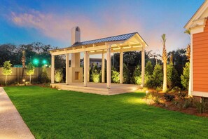 Enjoy a peaceful outdoor space surrounded by lush greenery and a beautifully maintained pergola.