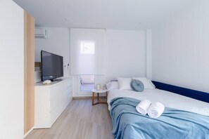 A modern hotel room with a bed, a TV, a small table, and a window. - Amazing Between Two Seas by Fidalsa (Murcia)