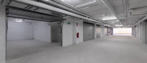 A large, empty parking garage with multiple levels and a central walkway.