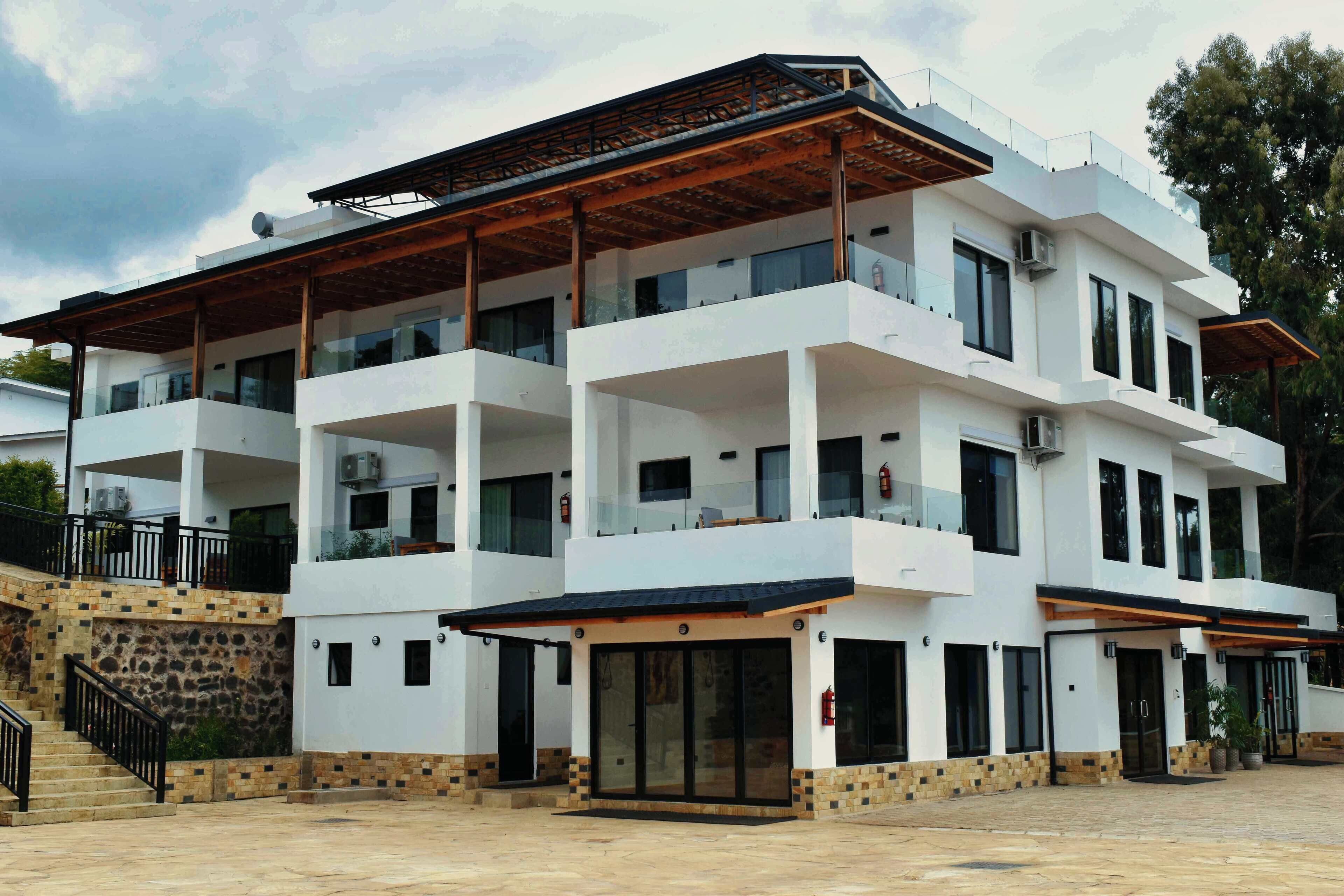 A multi-story hotel with a modern design, featuring balconies and large windows.