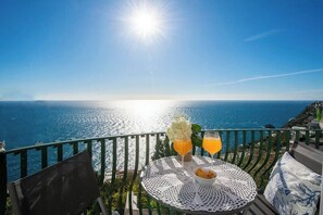A terrace with a table set for two, overlooking a coastal view. - De Vivo Realty - Mario's House (Praiano)