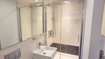 Shower, hair dryer, towels, shampoo