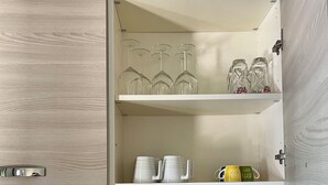 A kitchen with a built-in pantry, a stainless steel sink, and a gas stove.
