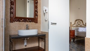 A bathroom with a sink, mirror, and hairdryer. - Speranzella 2 By Dimorra (NAPOLI)