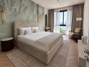 A modern hotel room with a large bed, a view of the city, and a balcony.