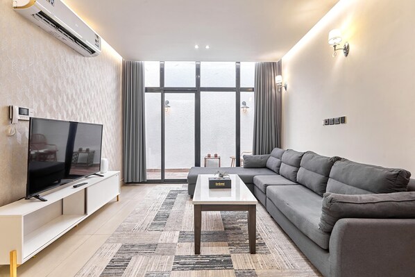 Premium Apartment, 3 Bedrooms | Living room | 45-inch Smart TV with satellite channels