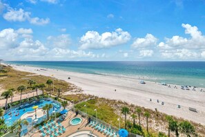 A beach resort with a swimming pool, lounge chairs, and a view of the ocean. - 6th Floor @ The Boardwalk, Directly on the Beach! Sleeps 6 (Panama City Beach)