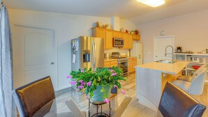 A modern kitchen with wooden cabinets, stainless steel appliances, and a central island with seating. - ~ 3 Mi to Ski & Hiking Trails: Soldotna Home (Soldotna)