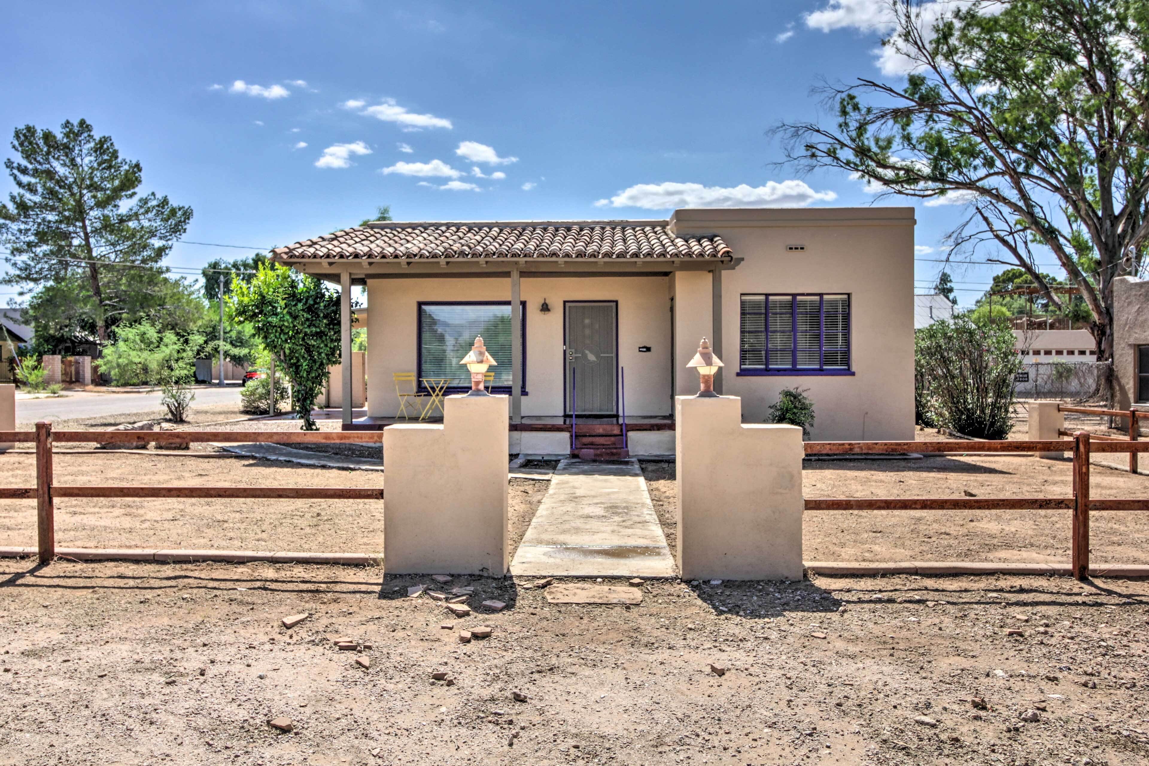 A single-story house with a tiled roof, a front door, and a small porch area.