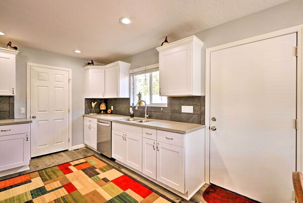 A kitchen with white cabinets, a granite countertop, and a colorful rug. - Show Low 'white Mountain Cottage' w/ Deck! (Show Low)